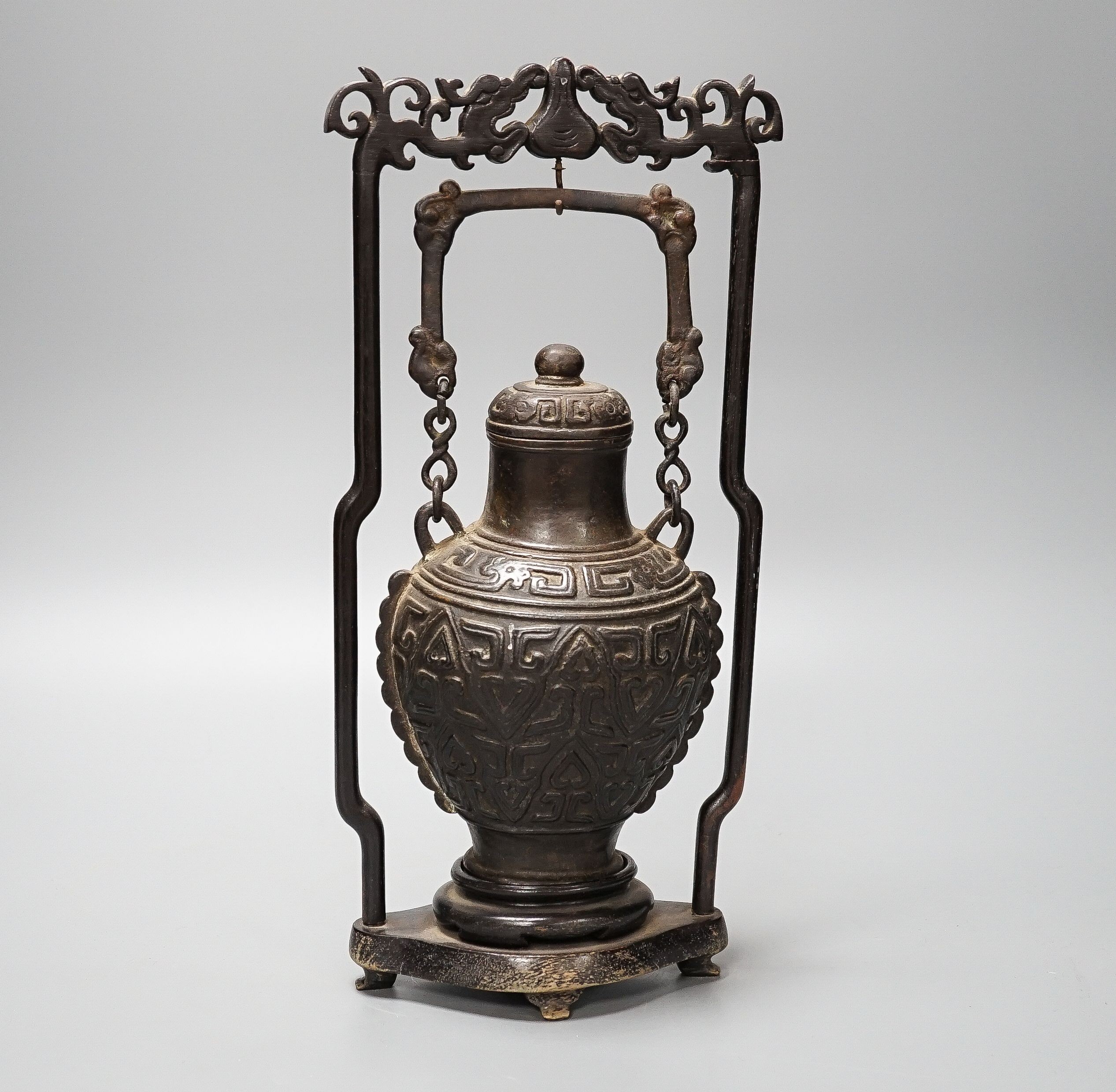 A Chinese archaistic bronze hanging vessel, wood stand 34cm